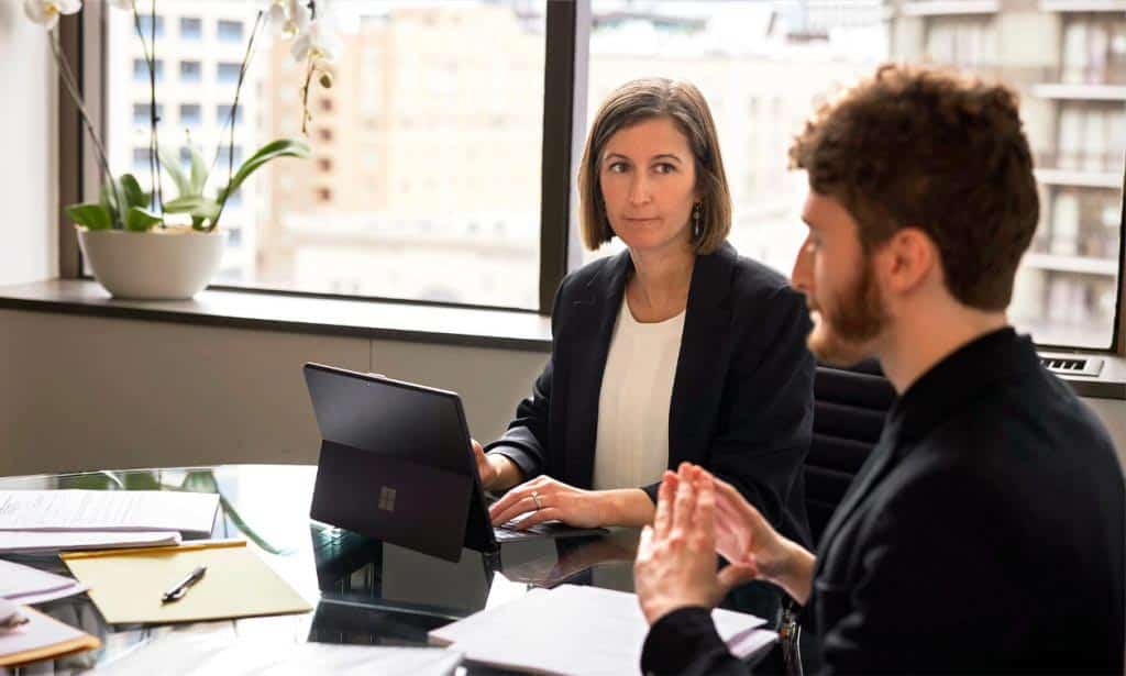 A female L&I attorney at Emery Reddy having a discussion with a client