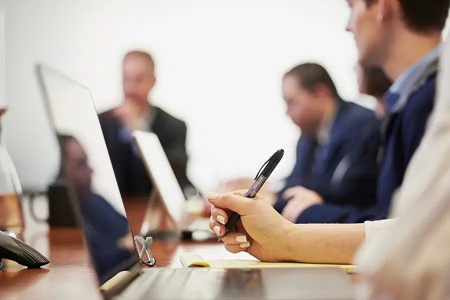 Several men working in a conference room.