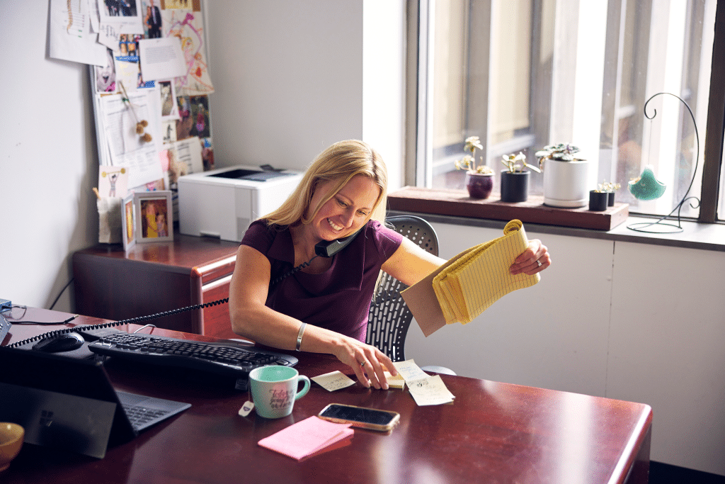 karolina arthur in her office on the phone with a client in the emery reddy downtown seattle offices